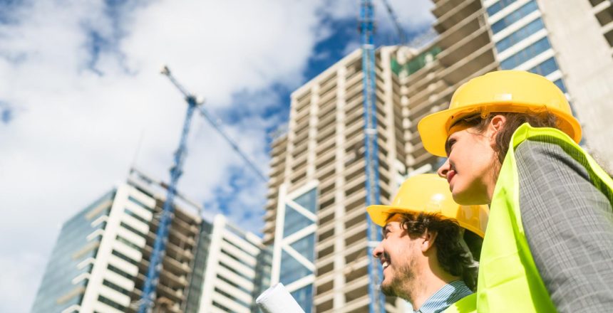Architects supervising progress of high rise project