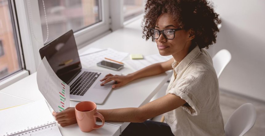 Young African female entrepreneur working at a table in a modern office