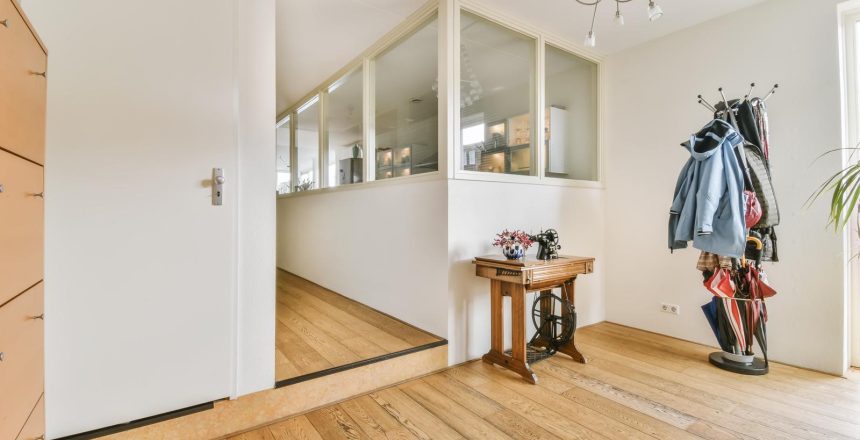 An adorable spacious hallway with a coat rack